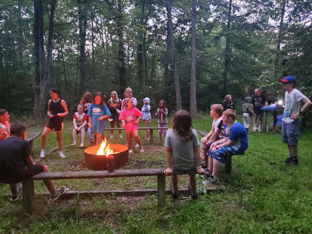 Youth Alternatives Kids Cooking S'mores around a campfire