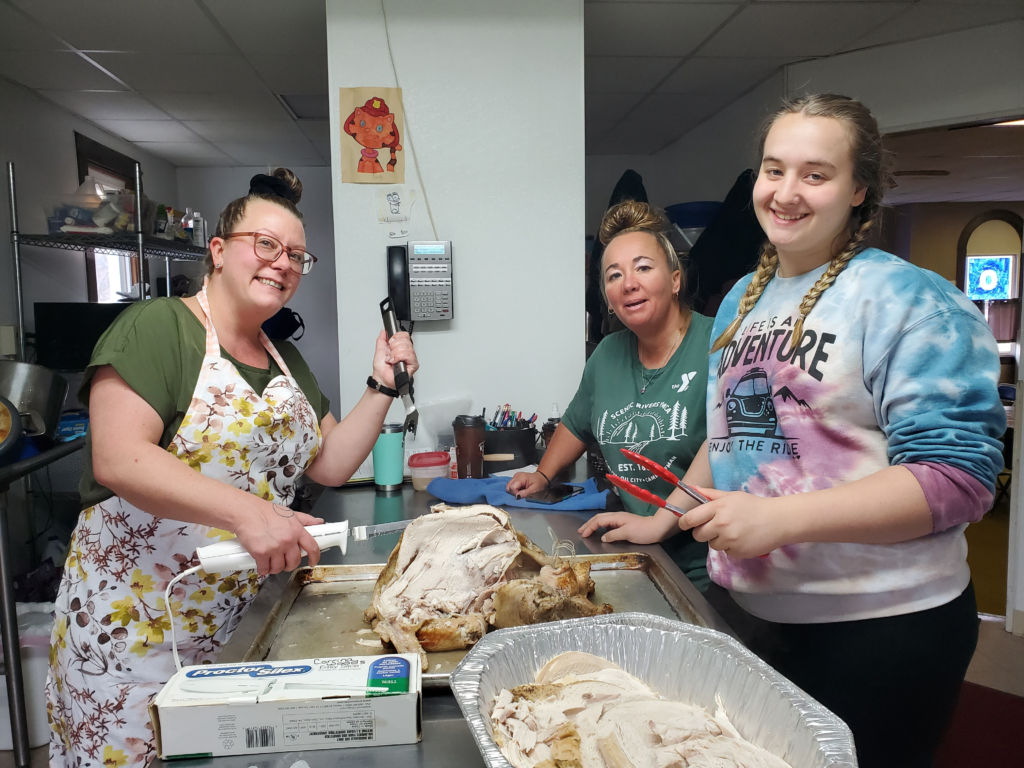 YA Executive Director Corinne Carbaugh having fun backing in the YA kitchen with other YA staff